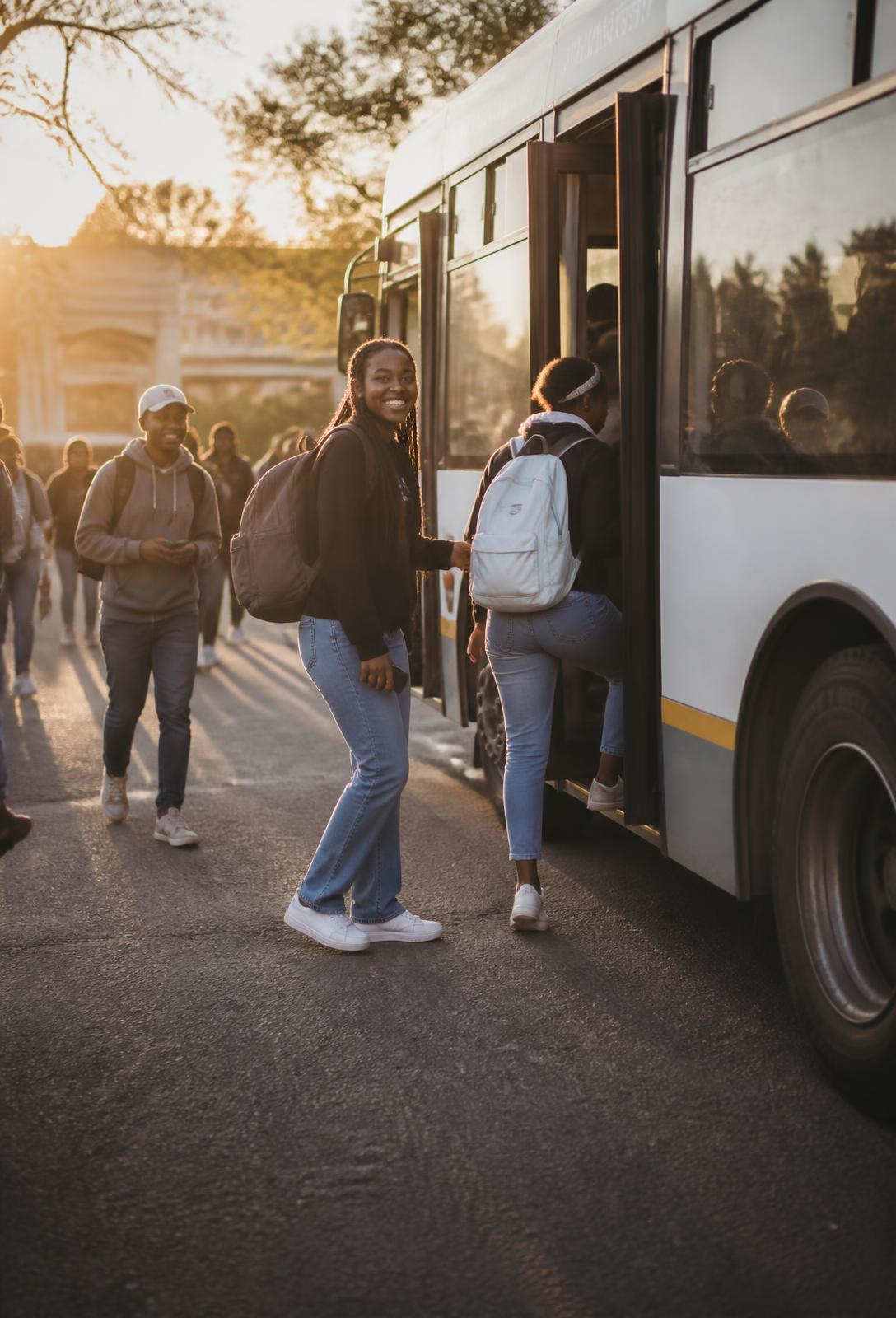 South African university students boarding a campus shuttle at golden hour
